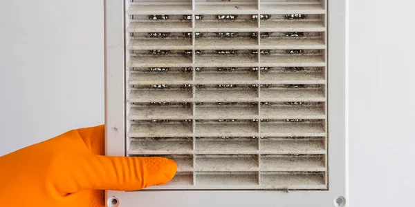 Dust and debris built up inside a return air grille